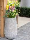Netherlands-Lisse. Tall flower pot with yellow tulips and narcissus. Art Print